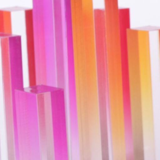 Translucent pink and orange acrylic trophy elements catching the light